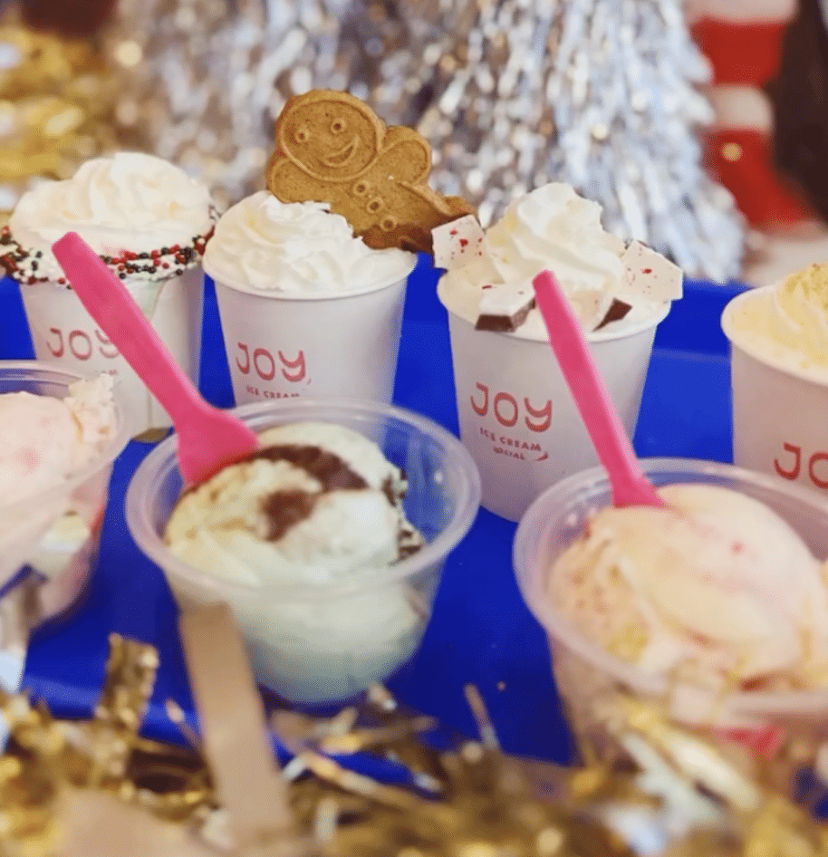 Hot cocoa flight with accompanying ice cream dishes and a gingerbread cookie at Joy Ice Cream in Wauwatosa